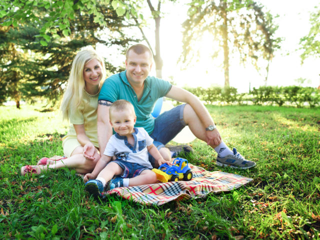 Young family sitting in a park