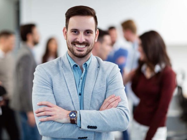 Group picture of businessman posing in office