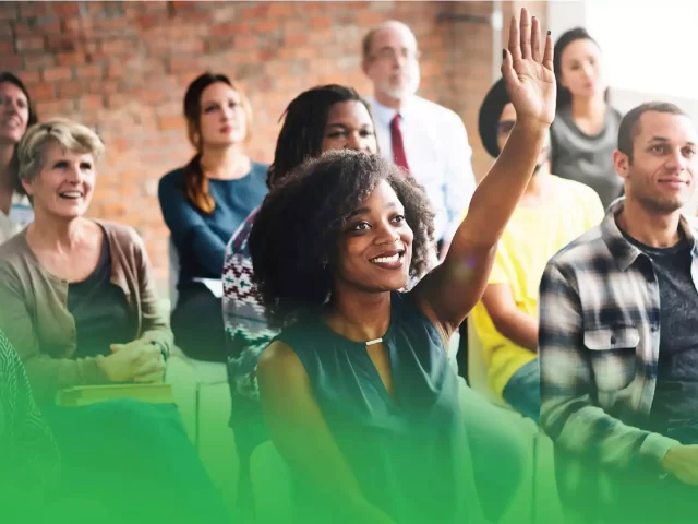 group of people in an ACR health patient presentation woman sitting in front raising hand